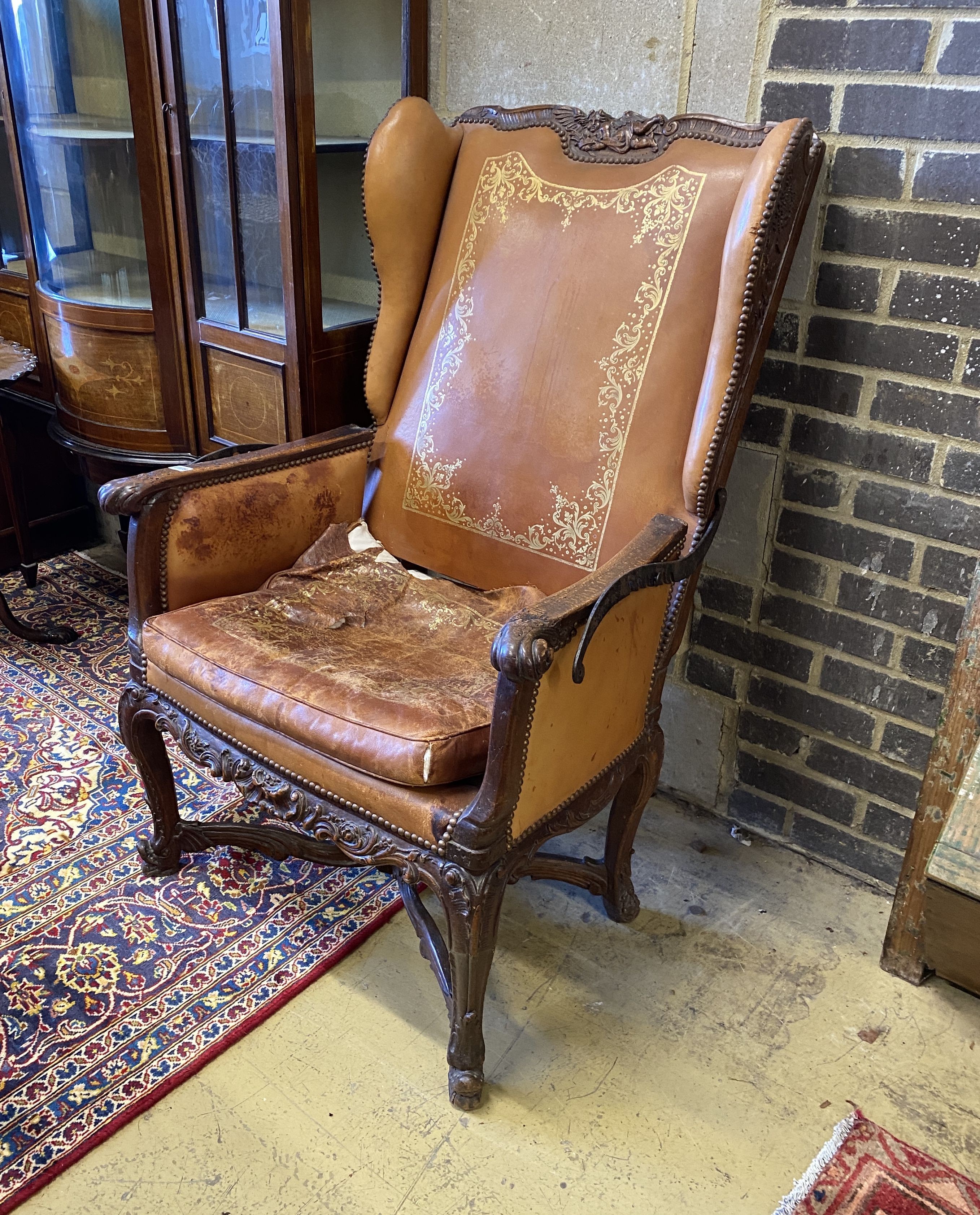 A 19th century French carved beech reclining armchair with original gilt leather upholstery, width 78cm, depth 74cm, height 114cm